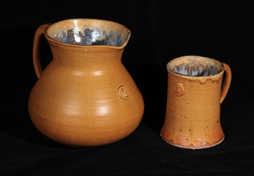 a pitcher and a mug glazed in ask and rutille