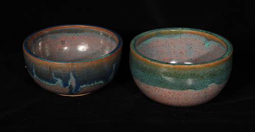 two bowl with the same base glaze, one rimmed with blue the other in green