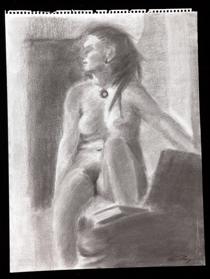 A seated nude looking right wearing a circular pendant