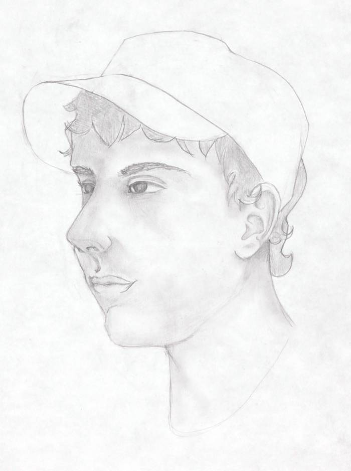 a profile portrait of a boy wearing a hat