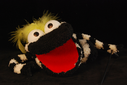 a black and white striped muppet like sock puppet